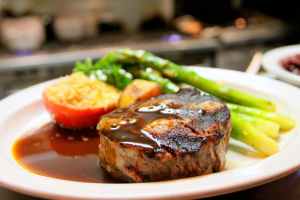 selective focus photography of beef steak with sauce